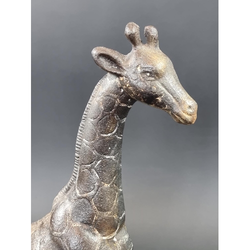 1242 - An unusual polychrome painted cast iron Giraffe door stop, 41.5cm high.