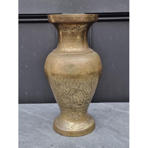 1243 - A Chinese brass vase, with engraved decoration, 39cm high.