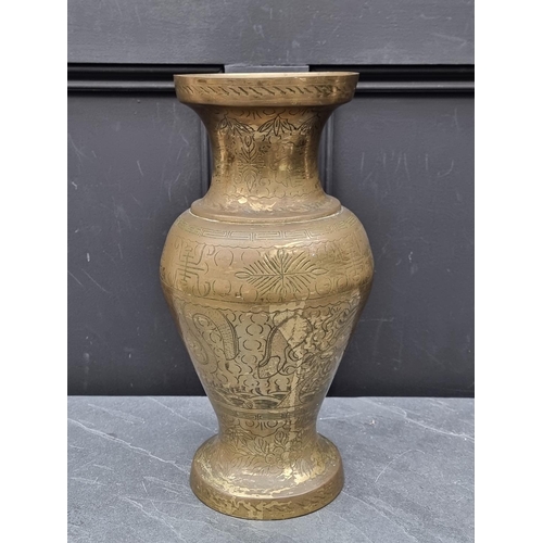 1243 - A Chinese brass vase, with engraved decoration, 39cm high.