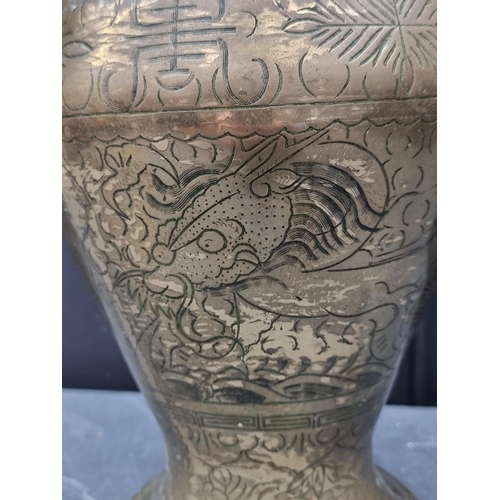 1243 - A Chinese brass vase, with engraved decoration, 39cm high.