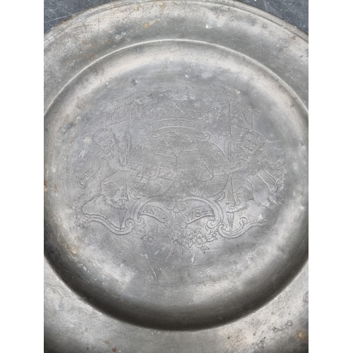 1255 - A collection of antique pewter, to include a large charger, dated 1784, 42.5cm diameter; and a nauti... 