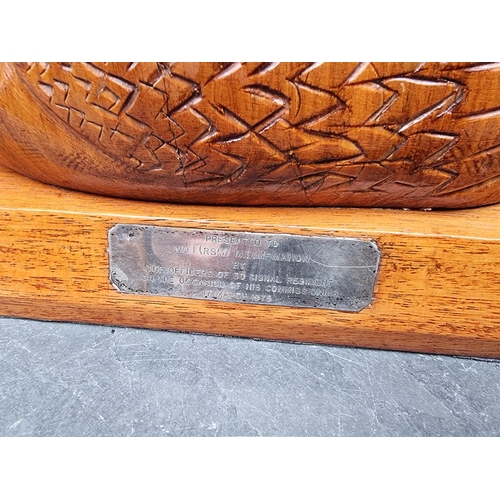 1262 - A carved hardwood swan presentation, 28.5cm wide; together with the Commercial Register of Canada, p... 