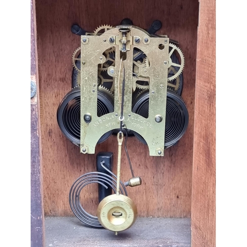 1266 - An old stained oak mantel clock, 33cm high, with pendulum.