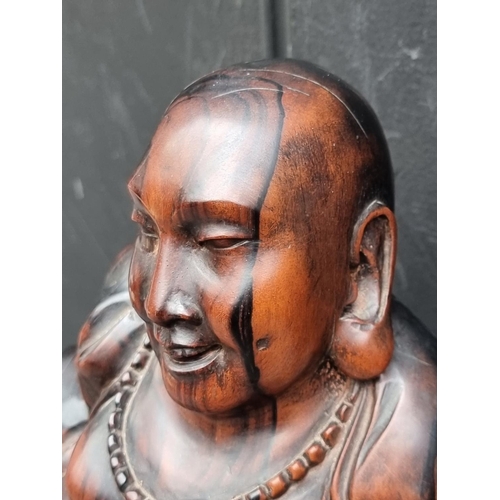 1267 - A Balinese carved hardwood Buddha, 32.5cm high.