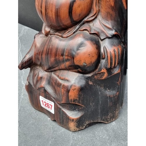 1267 - A Balinese carved hardwood Buddha, 32.5cm high.