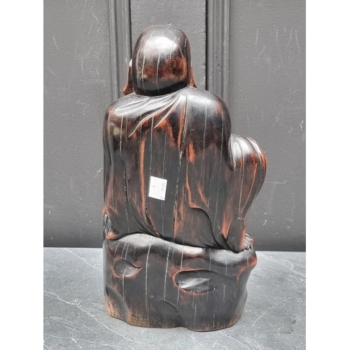 1267 - A Balinese carved hardwood Buddha, 32.5cm high.