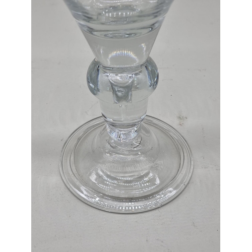 1295 - An 18th century glass baluster wine goblet, 18.5cm high. 