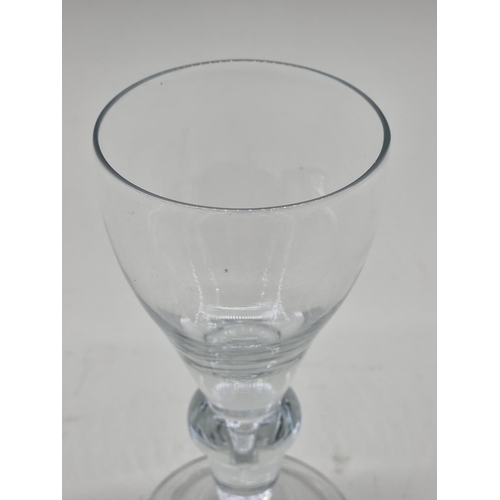 1295 - An 18th century glass baluster wine goblet, 18.5cm high. 