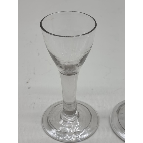 1298 - Two 18th century plain stemmed glasses, 12 and 14cm high respectively. (2)