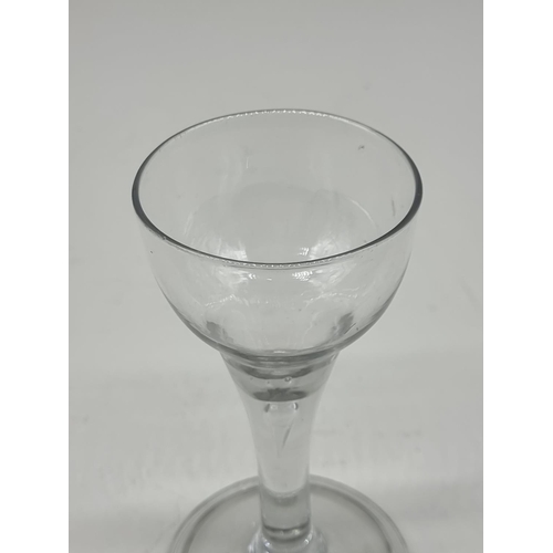 1303 - An 18th century wine glass, 14cm high.