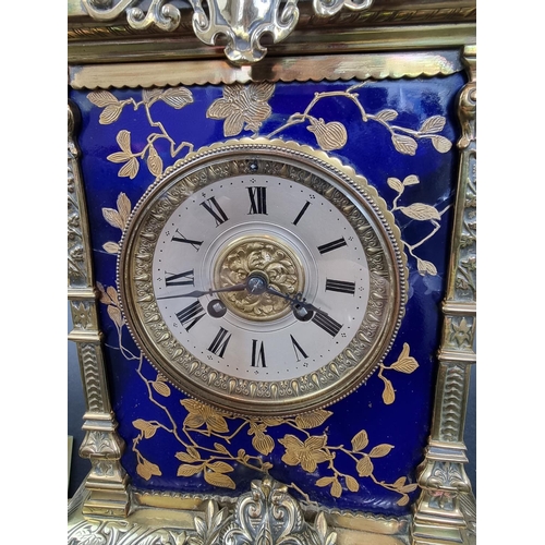 1383 - An impressive Victorian brass and porcelain clock garniture, the panels by Taylor, Tunnicliff & ... 