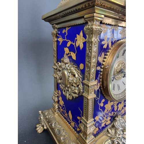 1383 - An impressive Victorian brass and porcelain clock garniture, the panels by Taylor, Tunnicliff & ... 