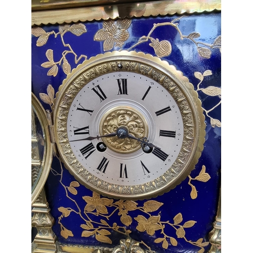 1383 - An impressive Victorian brass and porcelain clock garniture, the panels by Taylor, Tunnicliff & ... 