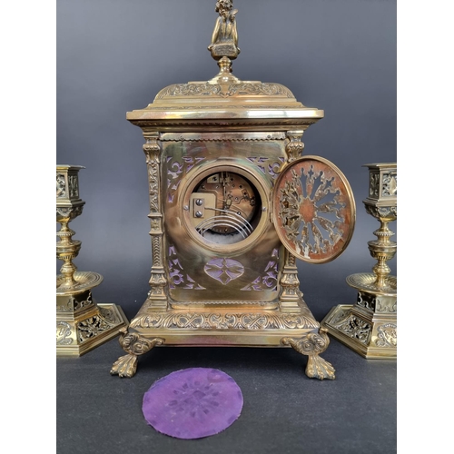 1383 - An impressive Victorian brass and porcelain clock garniture, the panels by Taylor, Tunnicliff & ... 