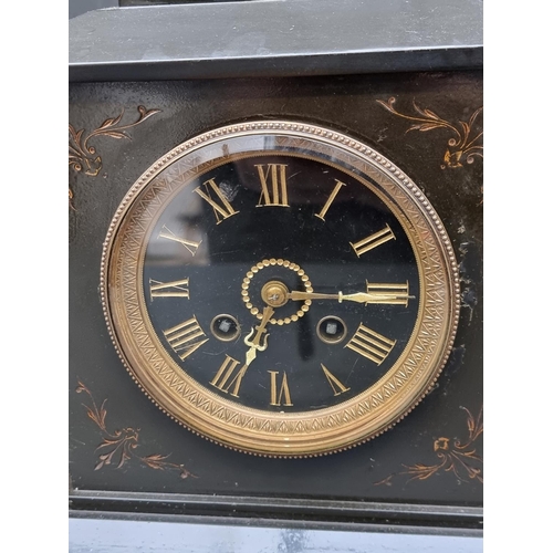 1409 - A late Victorian slate and brass mantel clock, 28.5cm high; together with a similar pair of side urn... 