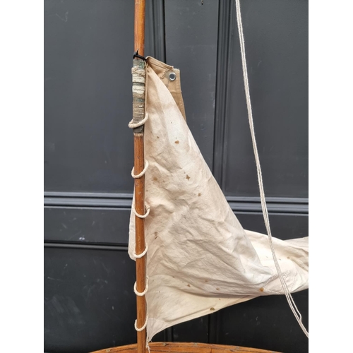 1417 - A vintage pond yacht, the hull 66cm long, on mahogany stand.