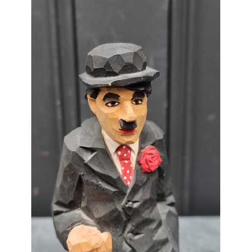 1436 - A carved and polychrome stained figure of Charlie Chaplin, by Urban Gunnarson, Stockholm, circa 1960... 