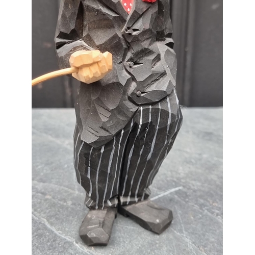 1436 - A carved and polychrome stained figure of Charlie Chaplin, by Urban Gunnarson, Stockholm, circa 1960... 