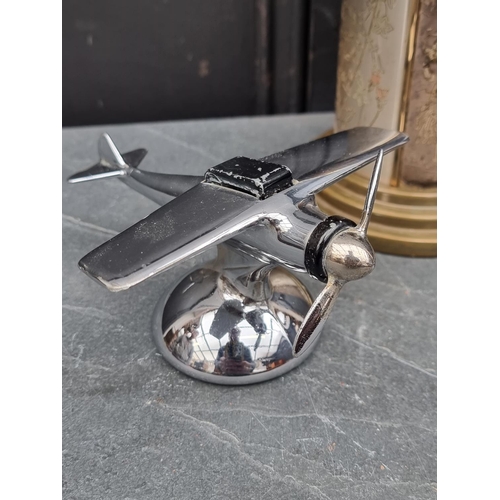 1444 - A vintage chrome plated novelty aeroplane cigarette lighter, wingspan 12.5cm; together with a chinoi... 