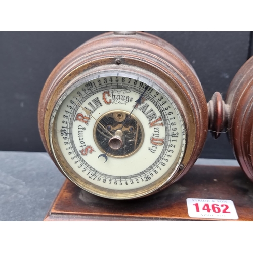 1462 - A late Victorian walnut combined clock and barometer set, with ivorine dials, 23.5cm wide.... 