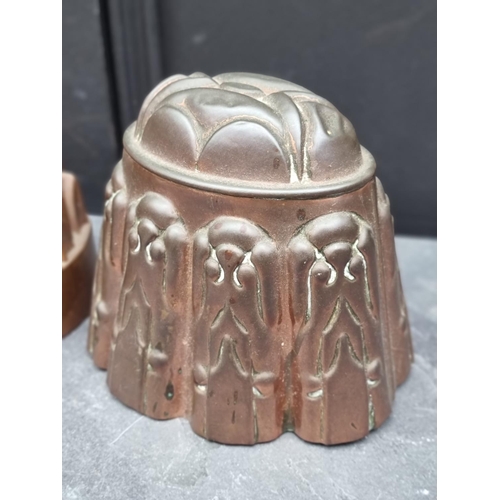 1474 - Three antique copper jelly moulds, largest 14cm high. (3)