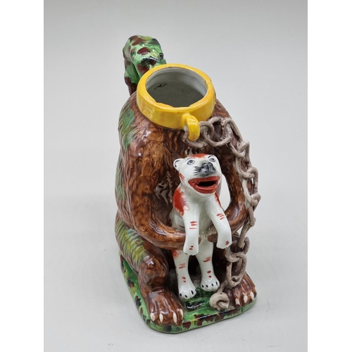 1507 - A reproduction Staffordshire style 'Bears Grease' jug and cover, 29cm high.