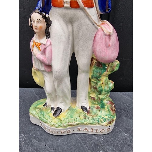 1535 - A large Victorian Staffordshire pottery figure of 'Begging Sailor', 43cm high.