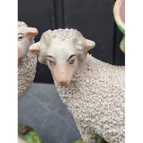 1538 - A pair of Victorian Staffordshire pottery sheep, 18cm high.