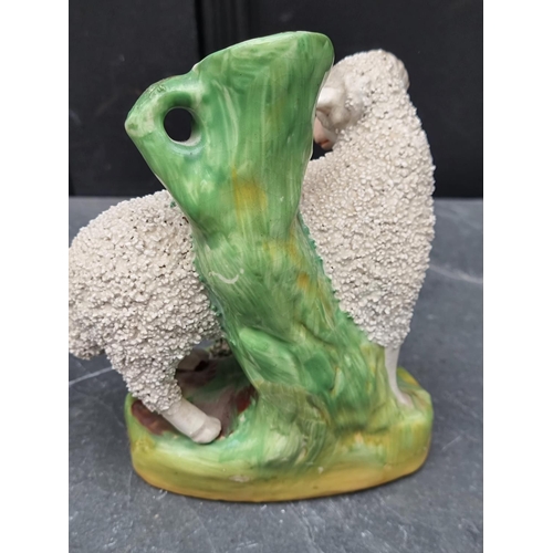 1538 - A pair of Victorian Staffordshire pottery sheep, 18cm high.