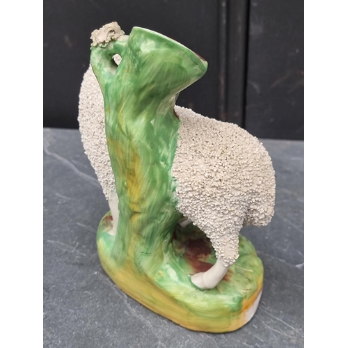 1538 - A pair of Victorian Staffordshire pottery sheep, 18cm high.