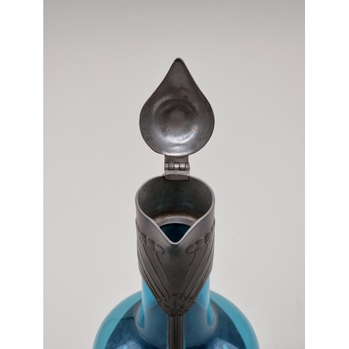 1550 - A Continental Art Nouveau pewter and blue glass claret jug, 29cm high.