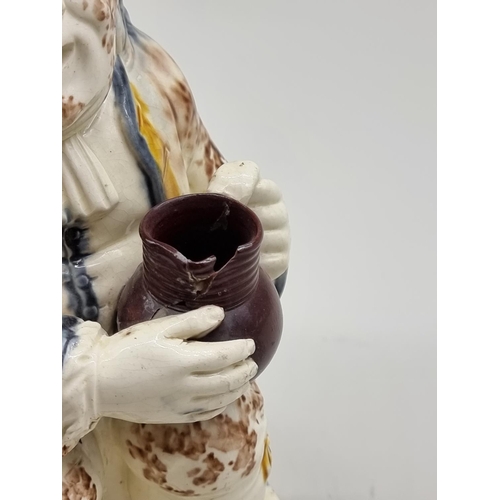 1558 - A late 18th century Creamware toby jug, 25cm high, (s.d.).