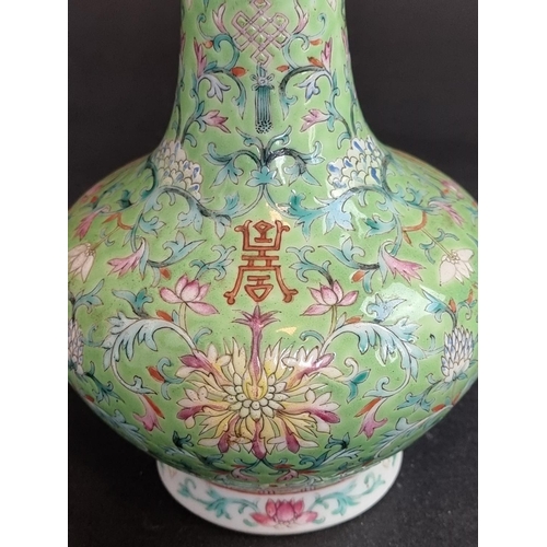 1578 - A Chinese lime-green ground famille rose vase, 17.5cm high.   