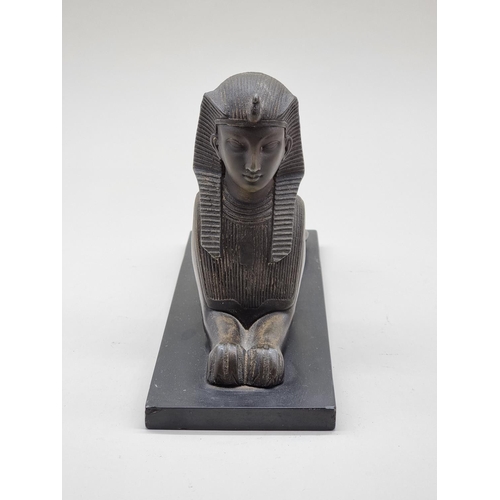 1583 - A bronze sphynx, on slate base, 28cm long.