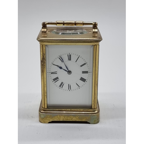 1590 - An old brass carriage timepiece, height including handle 18cm.