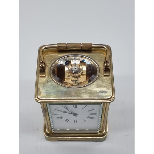 1590 - An old brass carriage timepiece, height including handle 18cm.