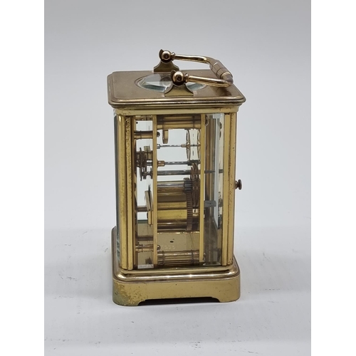 1590 - An old brass carriage timepiece, height including handle 18cm.