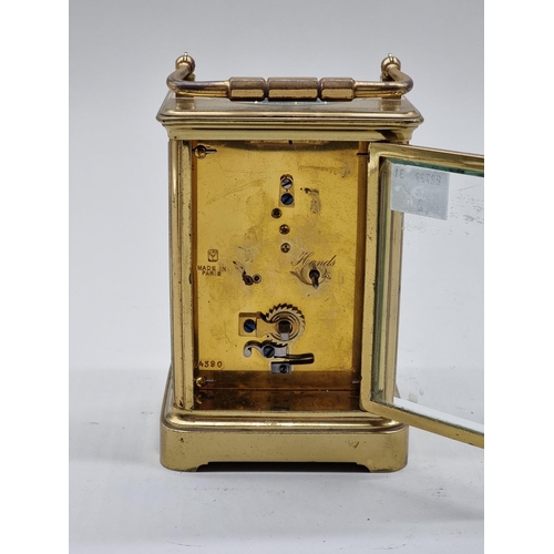 1590 - An old brass carriage timepiece, height including handle 18cm.