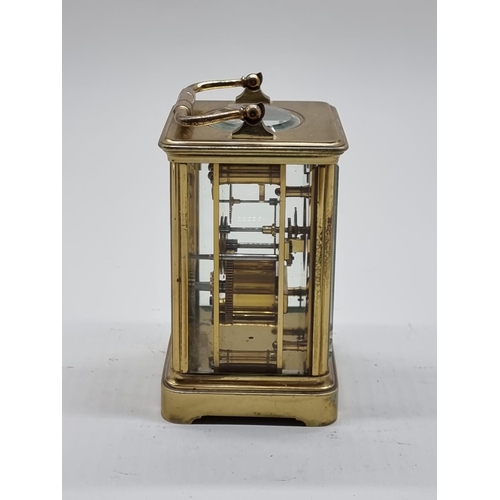 1590 - An old brass carriage timepiece, height including handle 18cm.