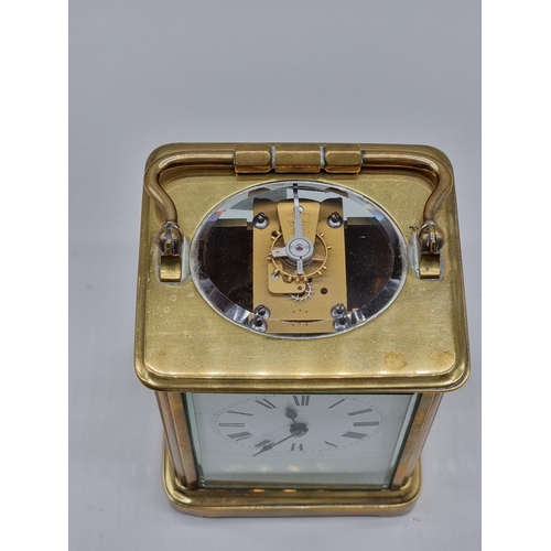 1591 - An old brass carriage timepiece, height including handle 17.5cm.