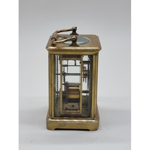 1591 - An old brass carriage timepiece, height including handle 17.5cm.