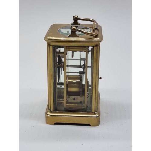 1591 - An old brass carriage timepiece, height including handle 17.5cm.