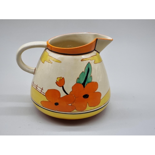 1598 - A Clarice Cliff 'Red Roofs' pattern Etruscan water jug, 20cm high.