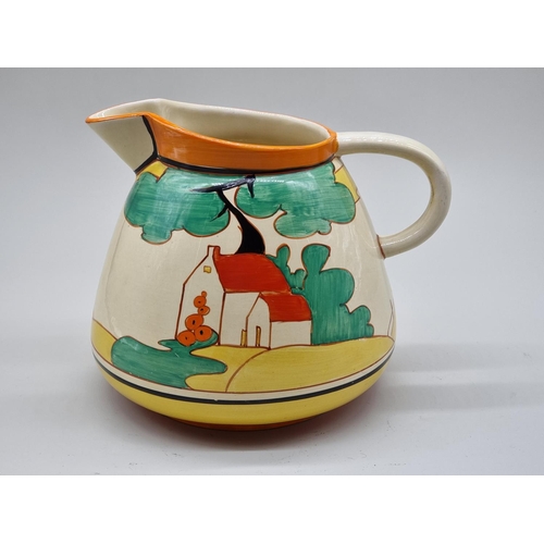 1598 - A Clarice Cliff 'Red Roofs' pattern Etruscan water jug, 20cm high.