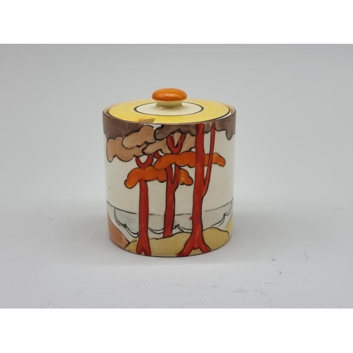 1606 - A Clarice Cliff 'Coral Firs' pattern preserve pot and cover, 7.5cm high.