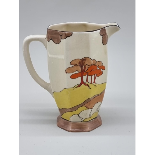 1609 - A Clarice Cliff 'Coral Firs' pattern Athens jug, shape 42, 15cm high.