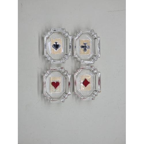 1639 - A set of four small glass card suit dishes, 6cm wide.