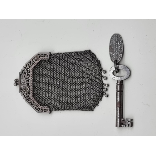 1643 - A vintage electroplated mesh purse; together with an old key. 