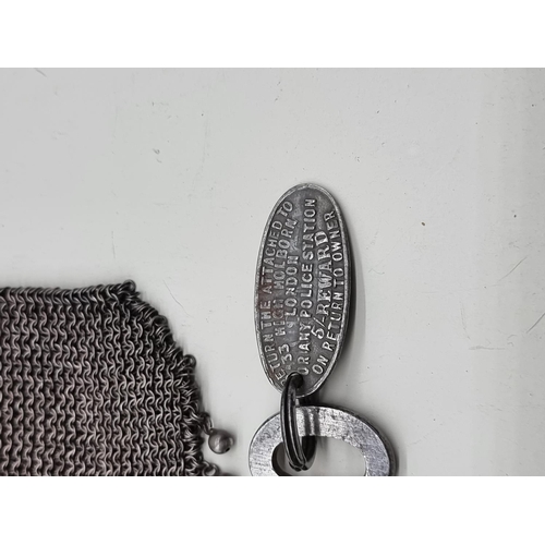 1643 - A vintage electroplated mesh purse; together with an old key. 