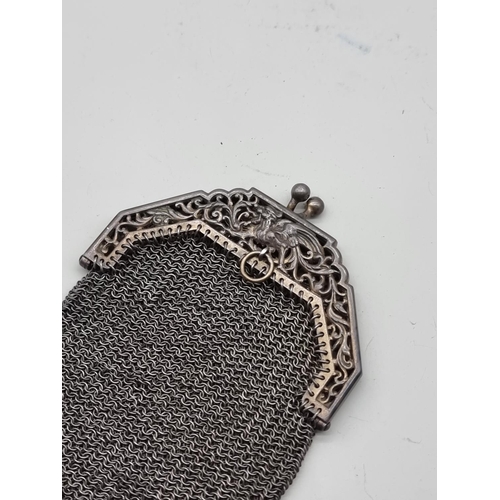 1643 - A vintage electroplated mesh purse; together with an old key. 